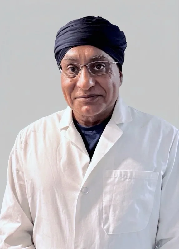 Dr. Gurpreet Singh Padda, MD, MBA, MHP, chief medical officer of Valor Villages, in a white lab coat.